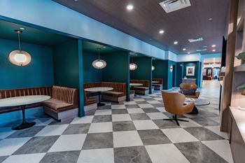 A room with a checkered floor and a blue wall.